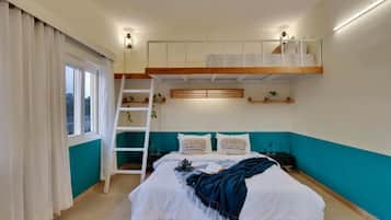 A bedroom with a bunk bed, a ladder, a window with curtains, and a teal accent wall.