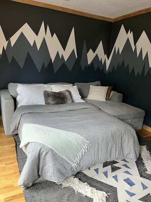 Ein Schlafzimmer mit Bett, Kissen und Decke.