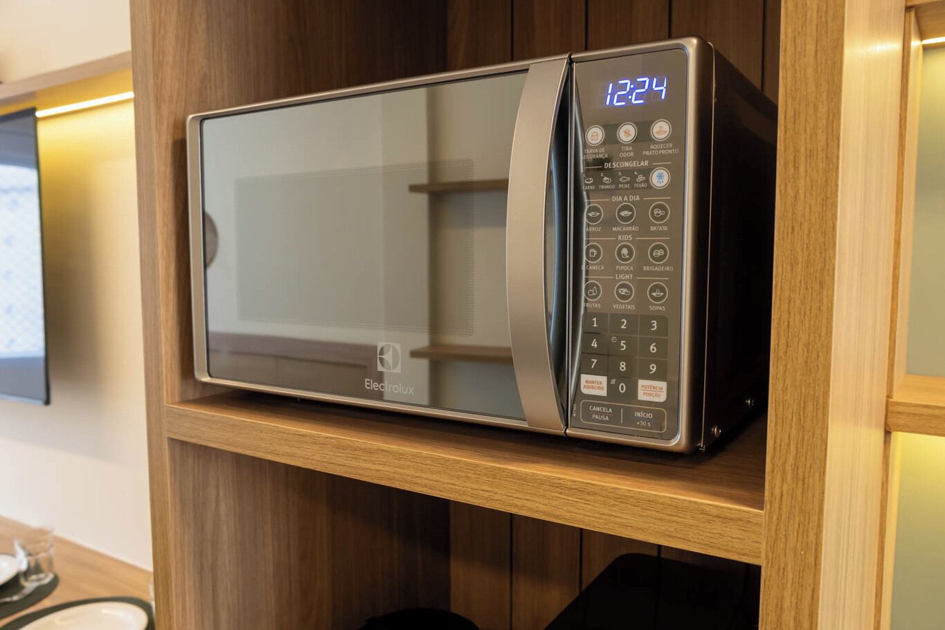 A microwave oven with a digital display, control panel, and brand logo.