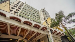 A multi-story building with a modern architectural design, featuring a prominent overhang structure and a visible store named "MAISON SAÏ". - Apartamento Aconchegante a 850m da Av Paulista (São Paulo)