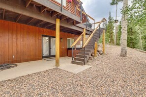 A wooden building with a balcony, a staircase, and a gravel driveway. - Hot Tub, Game Room! 3-Story Brian Head Home (Brian Head)