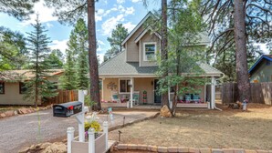 A two-story house with a front porch, surrounded by trees and a gravel driveway. - Less Than a Mile to Forest Roads/Trails (Flagstaff)