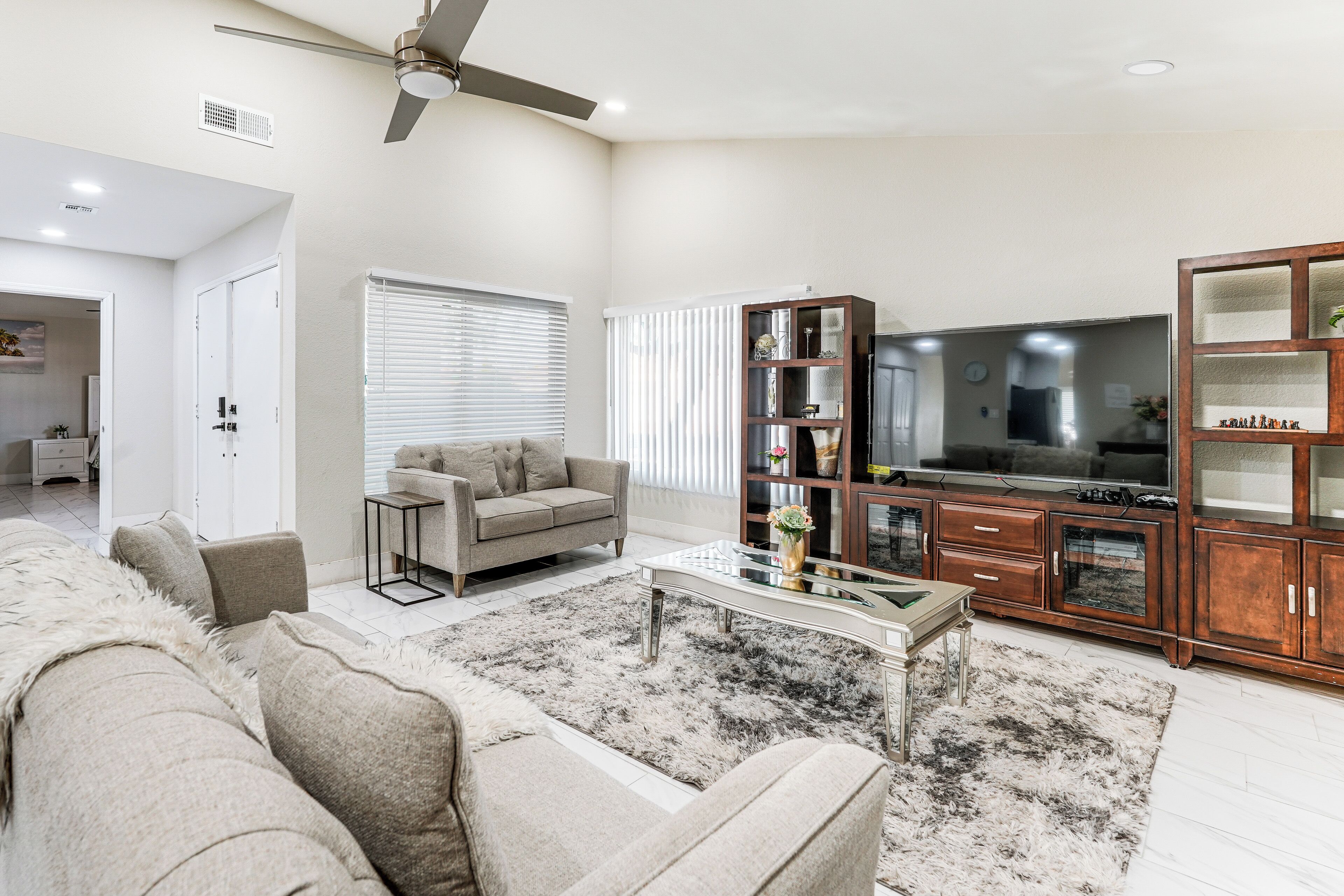 A living room with a sofa, coffee table, and TV stand.