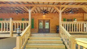 A wooden cabin with a central staircase leading to a door, surrounded by wooden railings and a ceiling fan. - Creek Access, Games: Family-Friendly Royal Retreat (Royal)