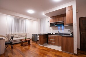 Deluxe Apartment | Living area | 32-inch Smart TV with digital channels