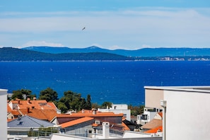 A coastal view with buildings and a clear blue sea.