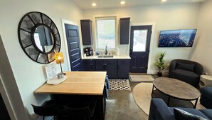 A compact living space with a kitchen, dining area, and seating area. - Walkable 1-Bed in East Nash, 2mi to DT, 5 Pts (Nashville)