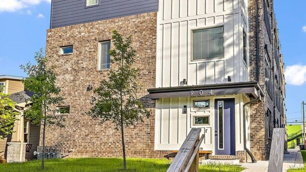 A multi-story residential building with a stone facade and a flat roof. - Walkable 1-Bed in East Nash, 2mi to DT, 5 Pts (Nashville)