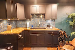 Fridge, microwave, coffee/tea maker, cookware/dishes/utensils