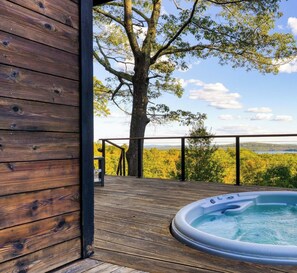 A wooden deck with a hot tub, surrounded by trees and a view of the landscape. - Modern Catskills Escape w/ Open Living, Steam Shower, & Hot Tub w/ Mountain Views, Minutes From Woodstock & Trails Suncliff Vista (Glenford)