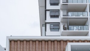 A modern cinema building with a prominent 'CINEMA' sign, large windows, and a balcony area. - Sea-View 3BR, Rooftop Pool, Secure Parking & Study (Wynnum)