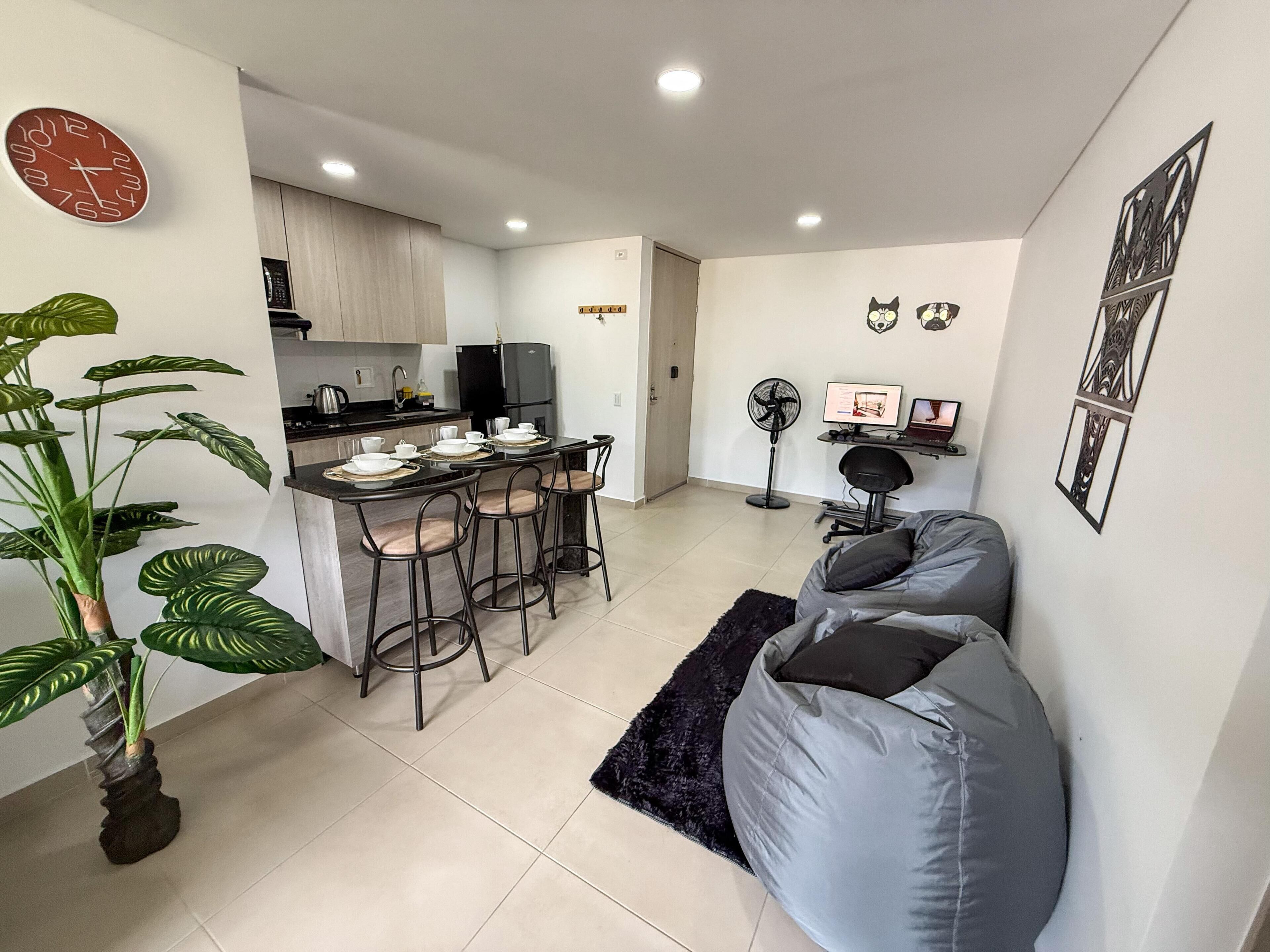 A modern living space with a kitchen, dining area, and seating area.