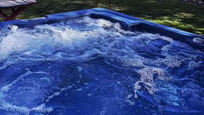 A hot tub in a backyard with a wooden fence and trees in the background. - Feel cozy and at home! Perfect Location For Exploring! (Provo)