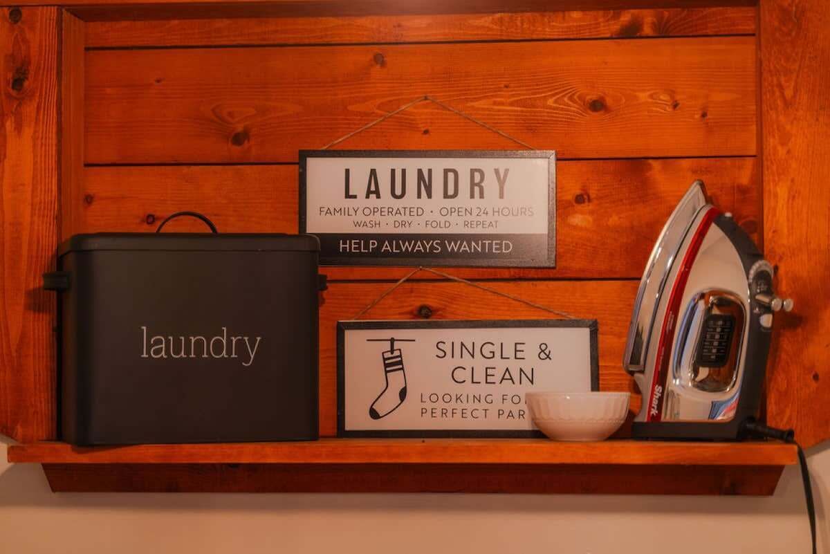 A laundry station with a sign indicating it's family-operated and open 24 hours.