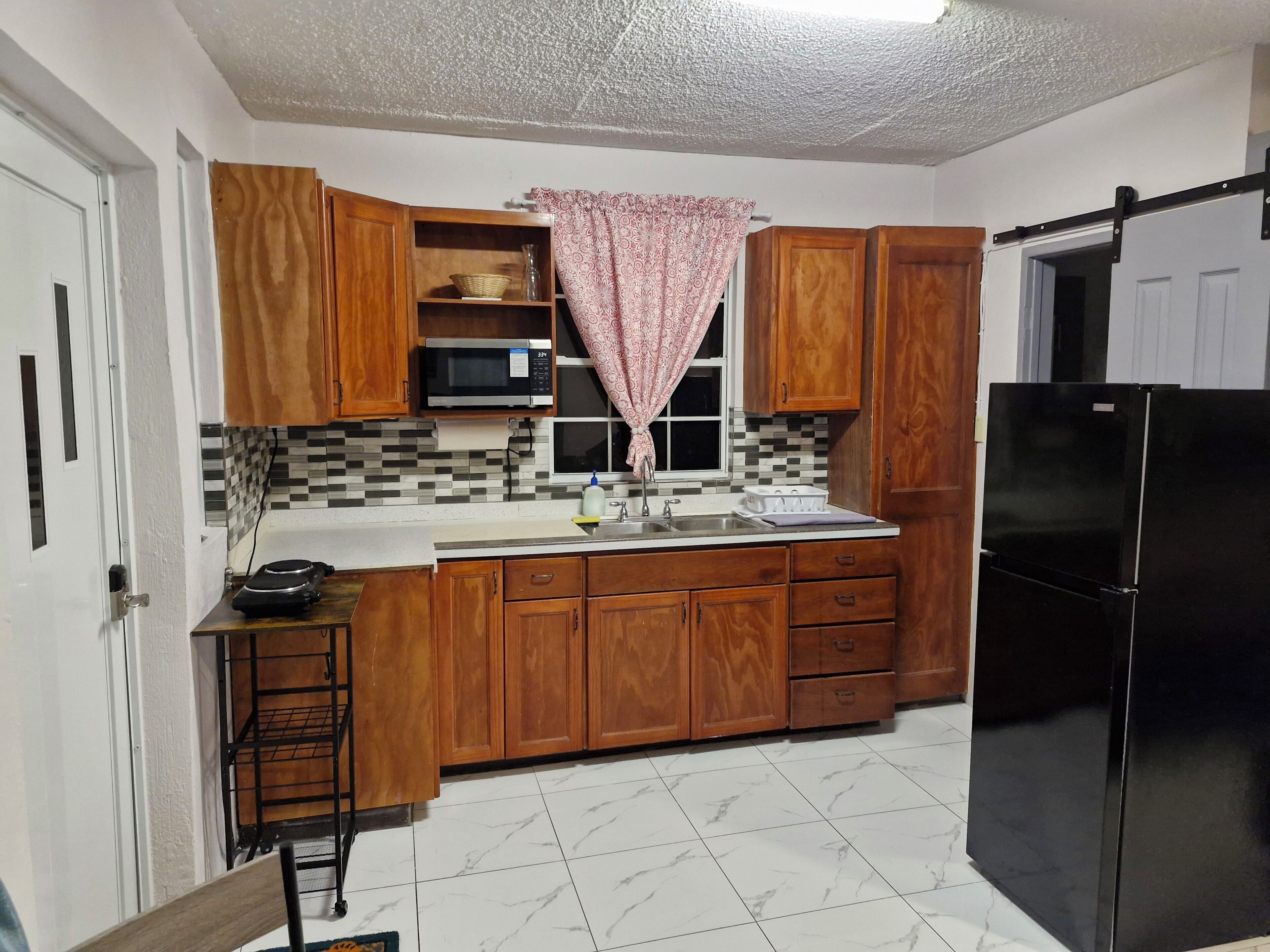 Fridge, microwave, stovetop, coffee/tea maker