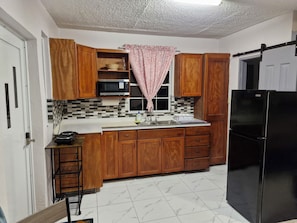 Fridge, microwave, stovetop, coffee/tea maker