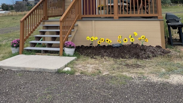 A wooden cabin with a porch, a staircase, and a 'WELCOME' sign. - Cozy Cabin w/ loft in charming Colorado Springs near USAFA (Colorado Springs)