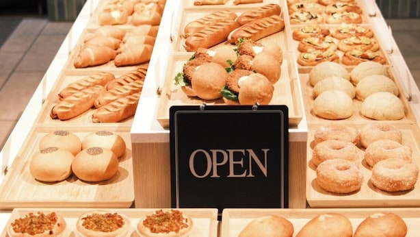 A bakery display with various baked goods and an 'OPEN' sign. - Hotel Elite Kyoto Station (Kyoto)