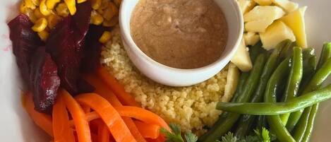 A plate with various vegetables and a bowl of dip.