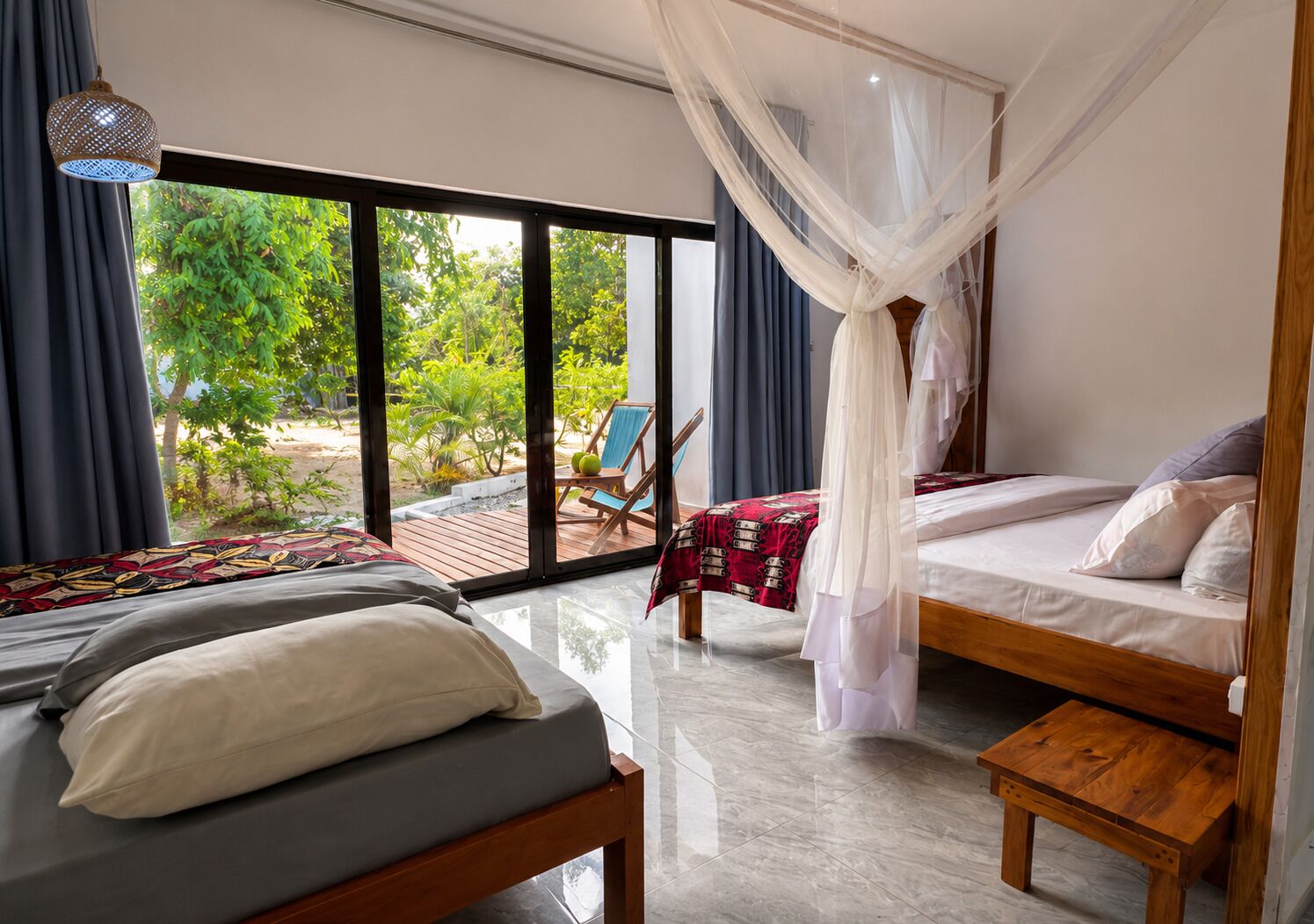A bedroom with a bed, a bench, and a view of the outdoors.