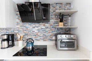 Fridge, stovetop, dishwasher, coffee/tea maker