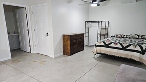 A bedroom with a bed, a wardrobe, a ceiling fan, and a door leading to another room. - Perfect 1-bedroom apartment in Marlette unit 2 (Marlette)