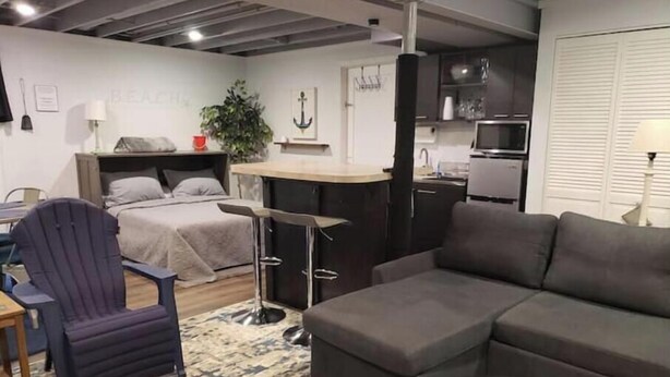 A compact living space with a bed, a sofa, a dining table, and a kitchen area. - Quiet, Roomy,  Private Studio,  Beautiful view. (Independence)