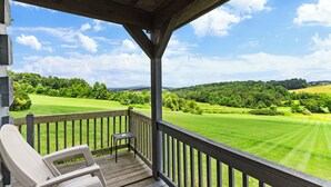 A wooden deck with a view of a green landscape and a clear sky. - 21 Acre Mountain Escape!  11 Private Cabins!  Weddings, Reunions, & Events! (Fancy Gap)