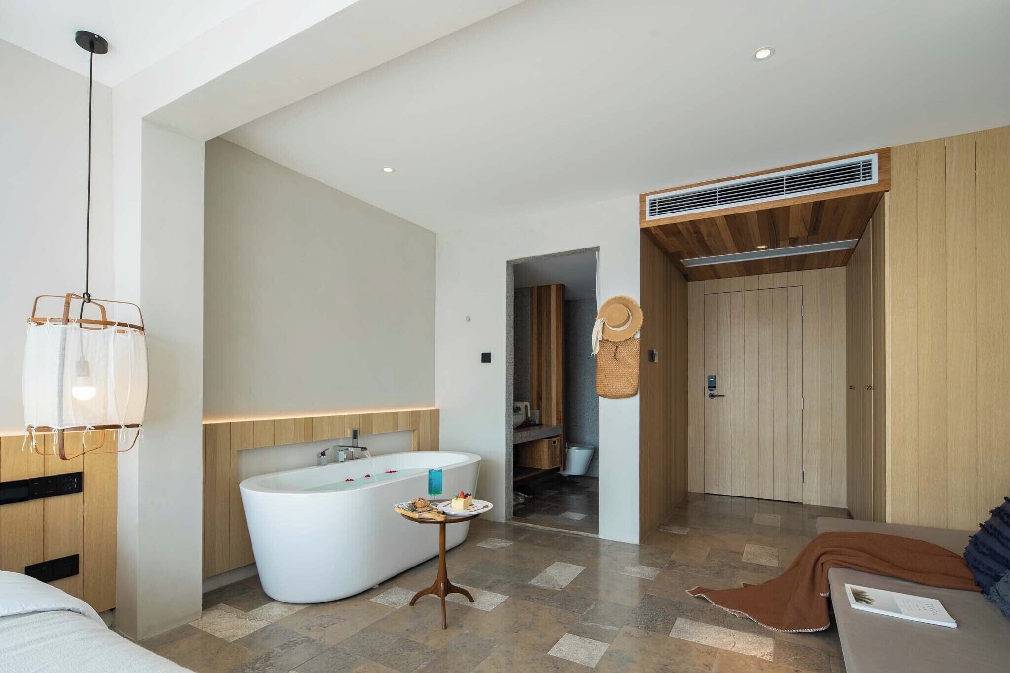 A modern bathroom with a freestanding bathtub, a vanity, and a shower area.