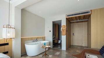 A modern bathroom with a freestanding bathtub, a vanity, and a shower area.