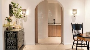 Una cocina moderna con encimera de madera, un fregadero y una silla negra.