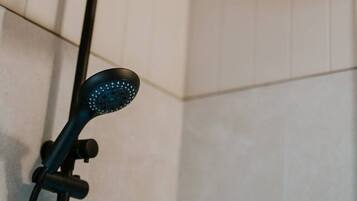 A showerhead with a curved design and a handheld shower attachment.