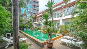 A pool area with lounge chairs and a potted plant. - Unwind Peaceful Near NaiHarn C200 (Rawai)