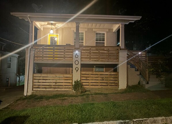 A two-story house with a balcony, a front door, and a mailbox. - Historic Alton duplex! Upper unit (Alton)