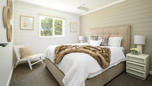 A bedroom with a large bed, a chair, a nightstand, and a window. - Ashbourne Farmhouse Near Woodend (Ashbourne)