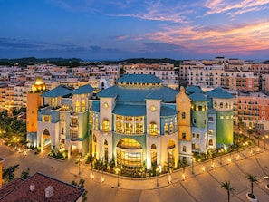 A multi-story hotel with a central courtyard, surrounded by other buildings. - Skywave Apartment Firework Delight (Phu Quoc)