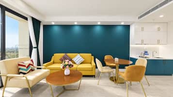 A modern living room with a yellow sofa, a coffee table, and a dining area with chairs.