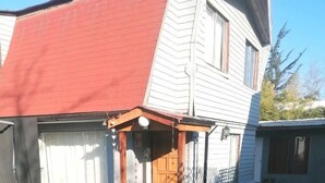 Una casa amb garatge, un porxo cobert i un carrer d'accés pavimentat.