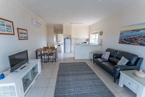 Luxury Apartment, Sea View | Living area | 32-inch flat-screen TV with digital channels