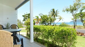 A covered outdoor seating area with a view of the sea and a sign reading 'Apollo Jewel.'