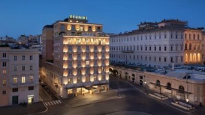 A hotel with a prominent 'BERNINI' sign, a central courtyard, and classic European architecture. - Sina Bernini Bristol, Autograph Collection (Rome)