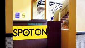 A reception desk with a sign reading "SPOT ON" and "Hotel Tour & Travel". - SPOT ON 2629 Duta Karimun (Karimun Jawa)
