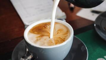 A cup of coffee with latte art on a saucer.