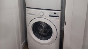 A stacked washer and dryer unit in a laundry room.