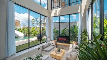 Family Villa, Pool View | Living room | Flat-screen TV