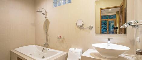 A bathroom with a bathtub, a toilet, a sink, and a shower.
