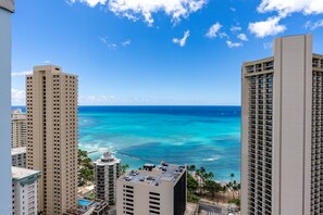 A high-rise hotel overlooking a beach with clear blue waters and a view of the ocean. - Newly Innovated Oceanview Beach Condo | Sauna Pool (Honolulu)