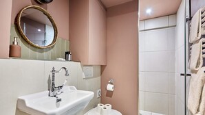 Un baño con lavabo, inodoro y zona de ducha.
