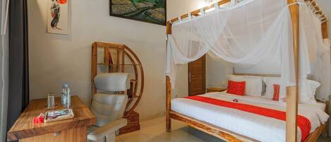 A bedroom with a four-poster bed, a wooden desk, and a chair.
