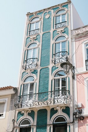 A building with a distinctive architectural style, featuring ornate balconies and a patterned facade. - Good Old Days (Caldas da Rainha)